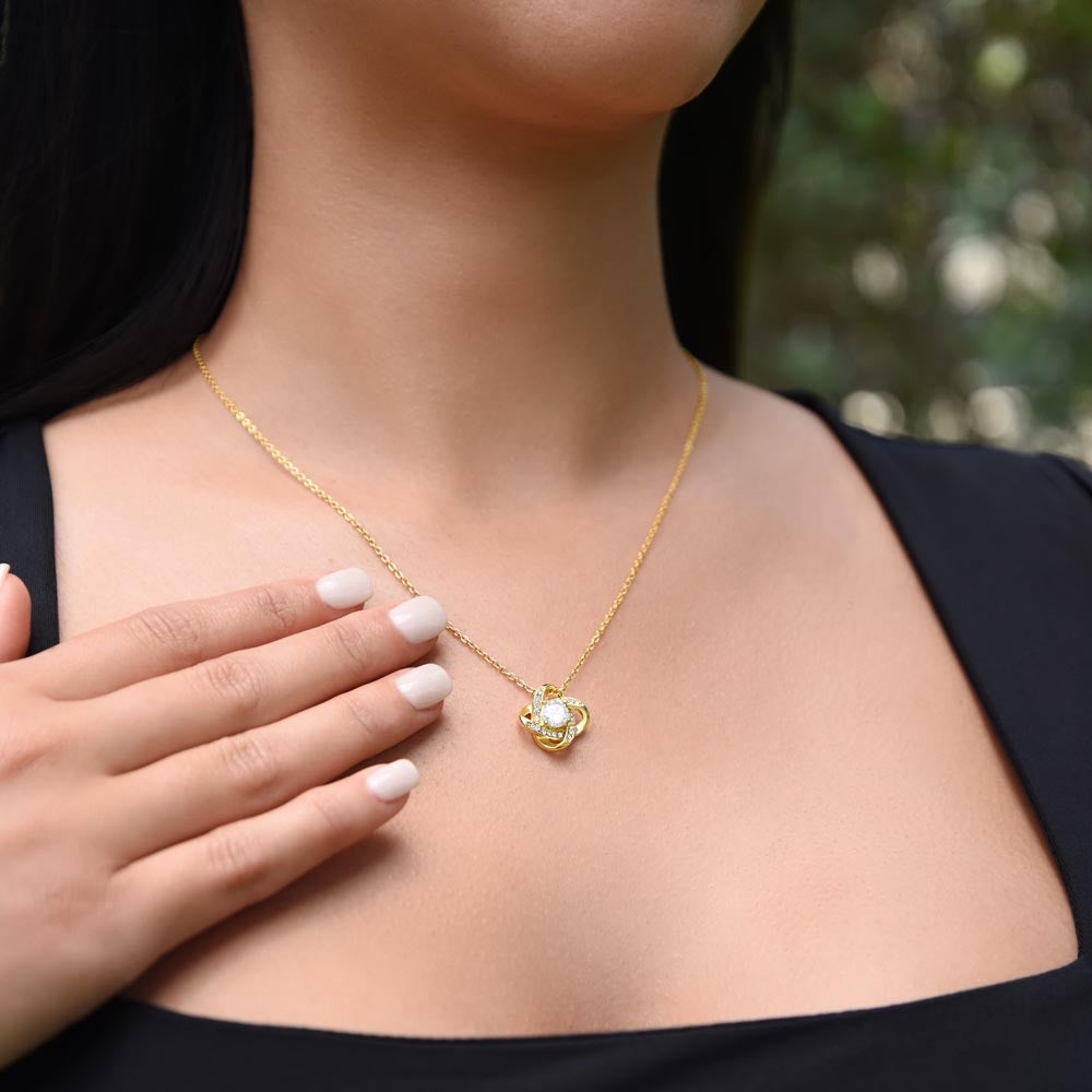 Woman wearing a 18K Yellow Gold Finish Love Knot Necklace